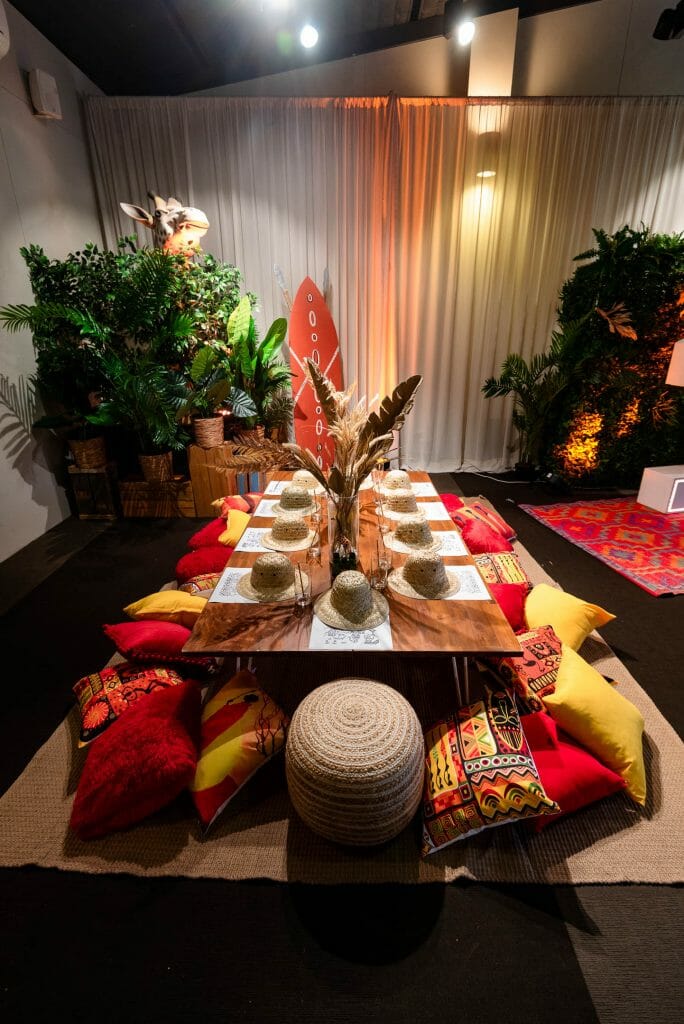 safari themed table setup with low lying table, cushions, and themed props