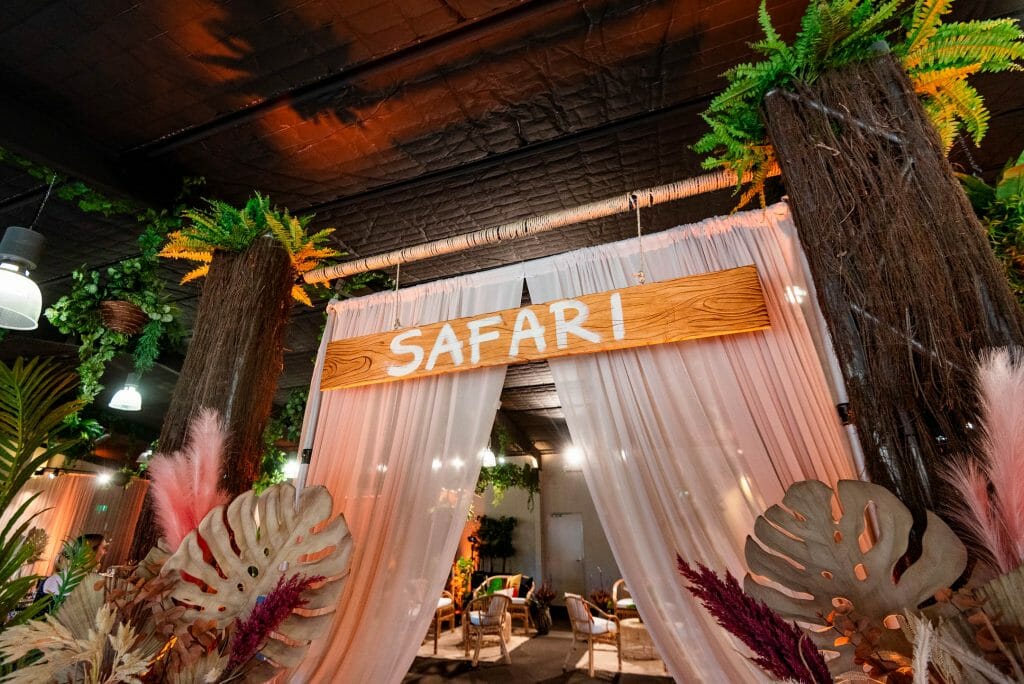 Safari themed entrance way with wooden sign and chiffon draping