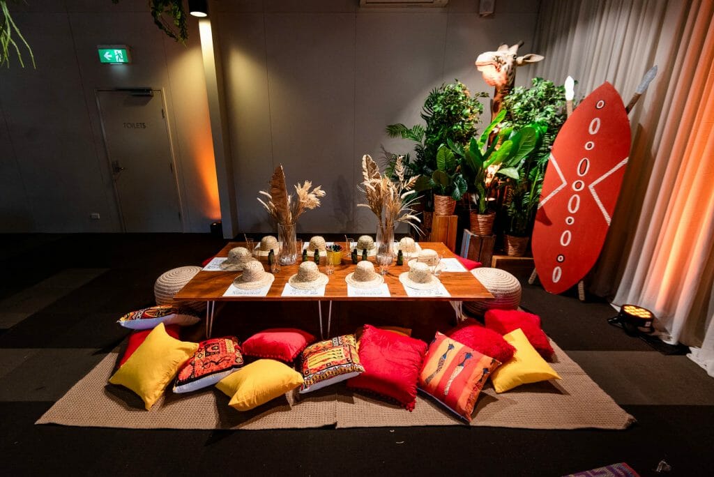 safari themed table setup with low lying table, cushions, and themed props