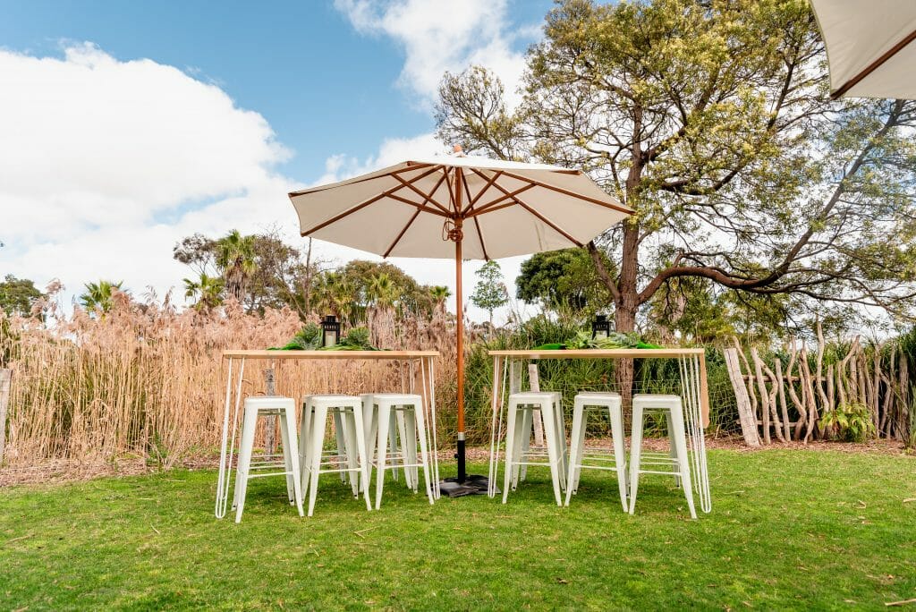 Don't let bad weather ruin your party bar tables and stools with umbrellas at werribee zoo events secret garden