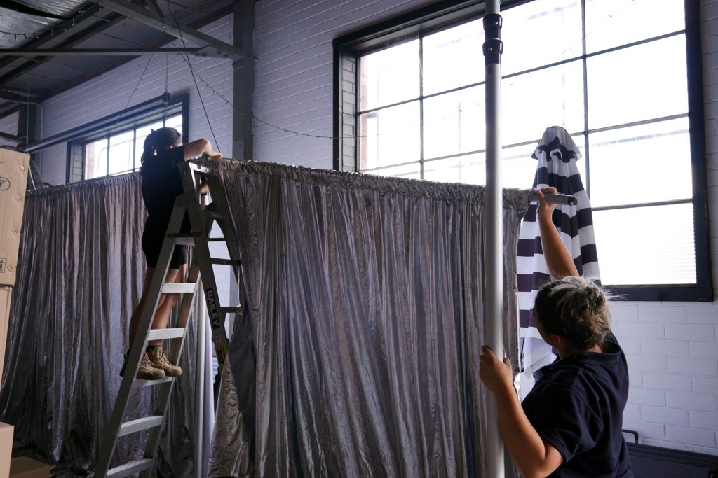 Staff - Carissa and Danni setting up drape