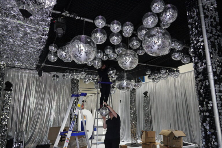 Team setting up silver disco party