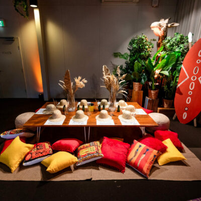 safari themed table setup with low lying table, cushions, and themed props