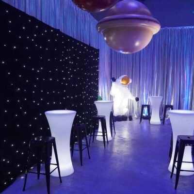 Star cloth and illuminated bar tables at space themed party top reasons for having a themed party