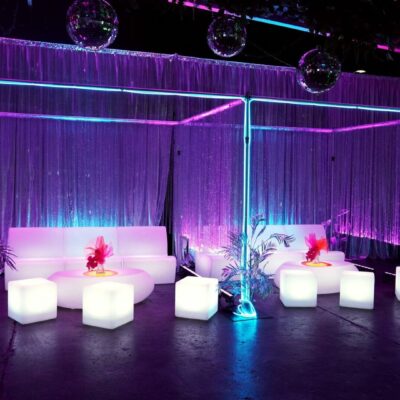 illuminated sofas, cubes, and coffee tables with beaded curtains, silver drape, neon lights and mirror balls party seating: how much do you need?