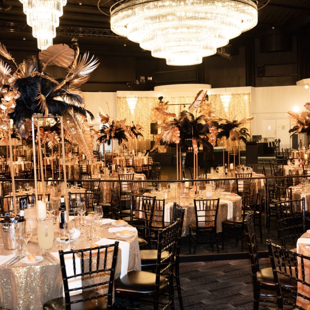 Gala Dinners black and gold floral centrepieces at 1920s themed end of year gala event planning services melbourne