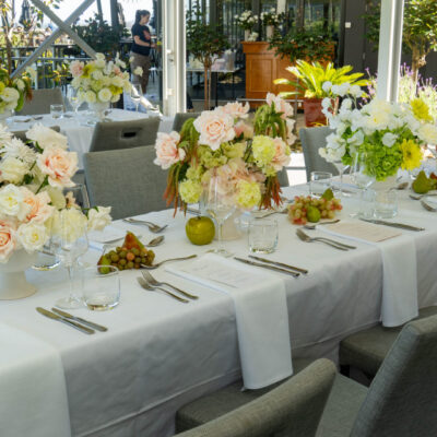 Fresh & Contemporary Wedding Style Wedding reception table setup with white linen, contemporary florals