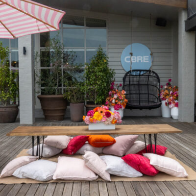 low lying table with cushions and bright floral centrepieces at greenfields albert park Episode 12: A Week at Feel Good Events