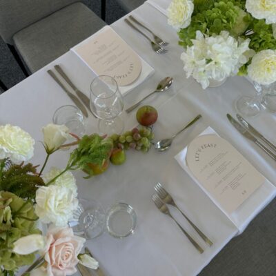 Wedding reception table setup with white linen, contemporary florals Wedding Decorating Trends for 2025