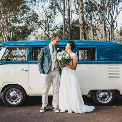 wedding couple in front of car